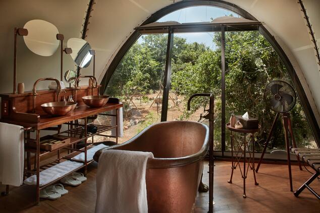 Handcrafted copper bathtubs are the ideal place to relax overlooking the jungle luxury safari trip yala sri lanka wildcoast tented lodge