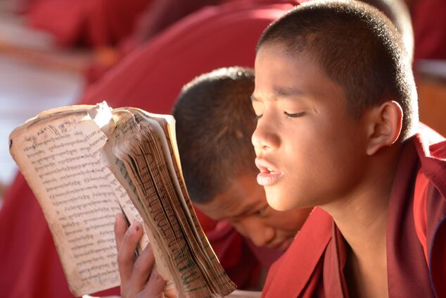 Young monk memorizing scriptures in Bhutan