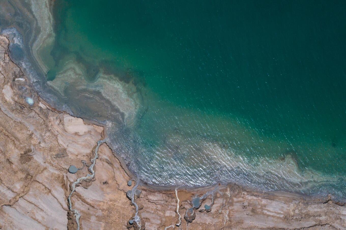 The waters of the Dead Sea, rich in minerals and its famous black mud, have very beneficial properties for the skin. travel remote luxury Jordan dead sea
