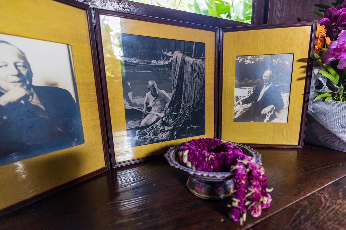 Black-and-white photographs of Jim Thompson on display at his Bangkok house museum.