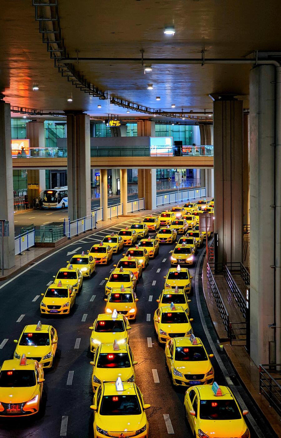 The city has an impressive fleet of official cabs, recognizable by their yellow color. During peak hours, it is common for passengers to share cabs, as drivers are allowed to pick up additional passengers. Photo: Jerry Wang. Photo: Jerry Wang. Chongqing. China.